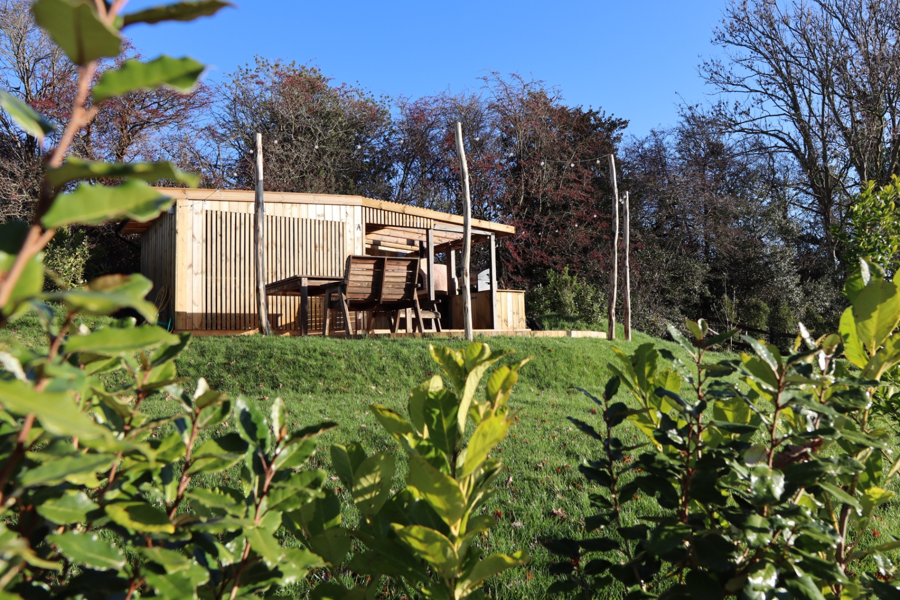 Timber garden pavilion with outdoor kitchen and wood-fired oven